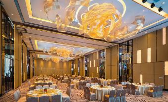 The ballroom is decorated and set up with tables and chairs for an event at Baiyun Hotel