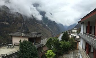 The balcony at a person's house in Tianmen Mountain Village offers a scenic view at Tina's Youth Hostel