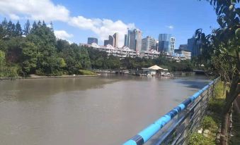 There is a river with buildings on both sides, including an artificial lake, and the skyline in the background at Beehome  Hostel