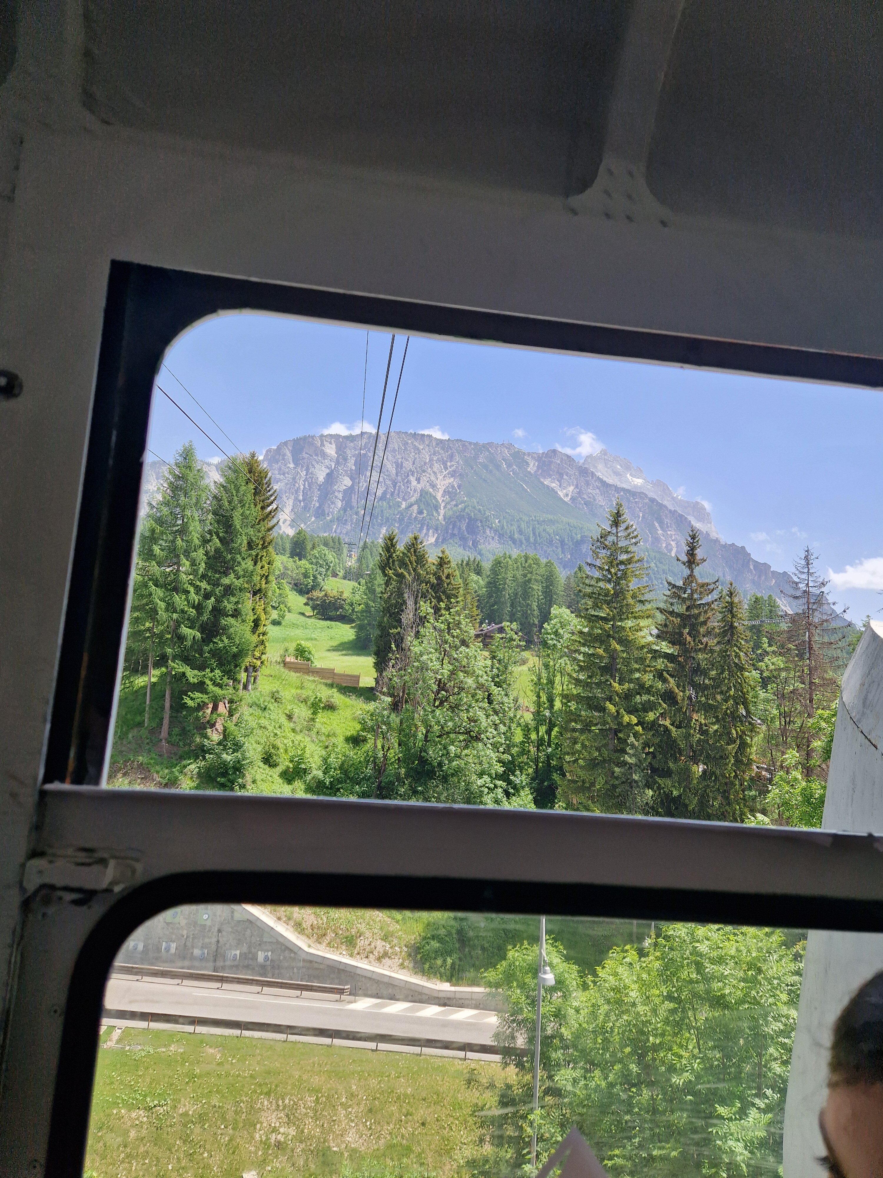 Faloria cable car ascending towards mountain peaks with panoramic views