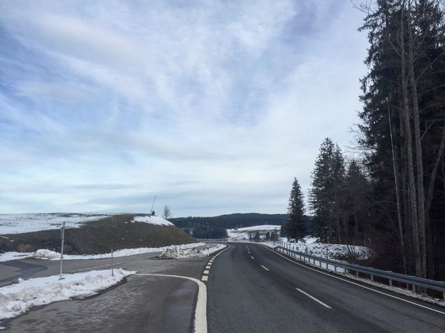 Wilderness church and snowy road scenery in the Bavarian Alps.