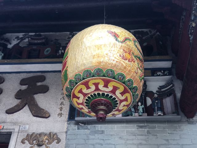 Historic temple with art work on the roof 