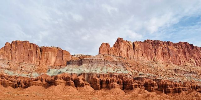 Colorful castle-like rock formations stand in groups, forming a unique landscape of undulating domes in the Joshua Tree National Park.