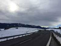 Wilderness church and snowy road scenery in the Bavarian Alps.