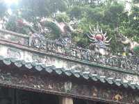 Historic temple with art work on the roof 