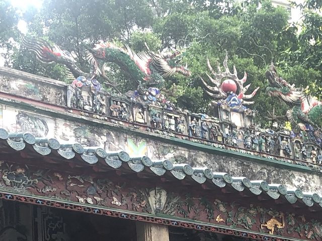 Historic temple with art work on the roof 