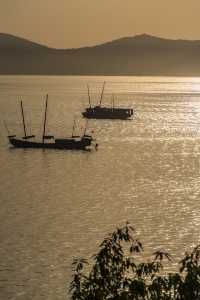 Fishing boats singing at dusk.