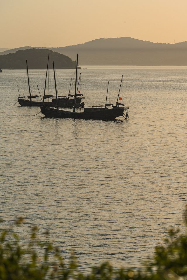 Fishing boats singing at dusk.