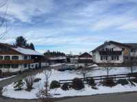 Wilderness church and snowy road scenery in the Bavarian Alps.