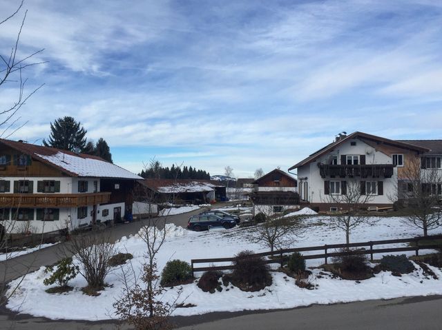 Wilderness church and snowy road scenery in the Bavarian Alps.