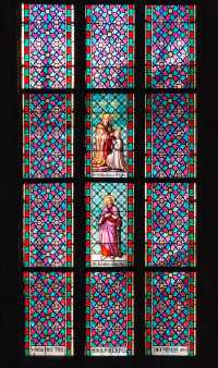 View St. Vitus Cathedral through the colorful stained glass windows.