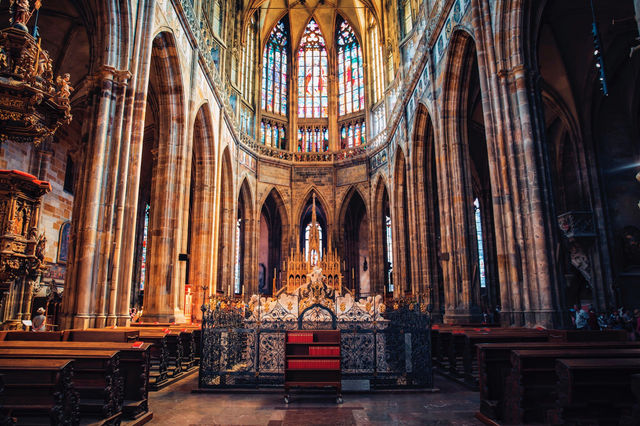 View St. Vitus Cathedral through the colorful stained glass windows.
