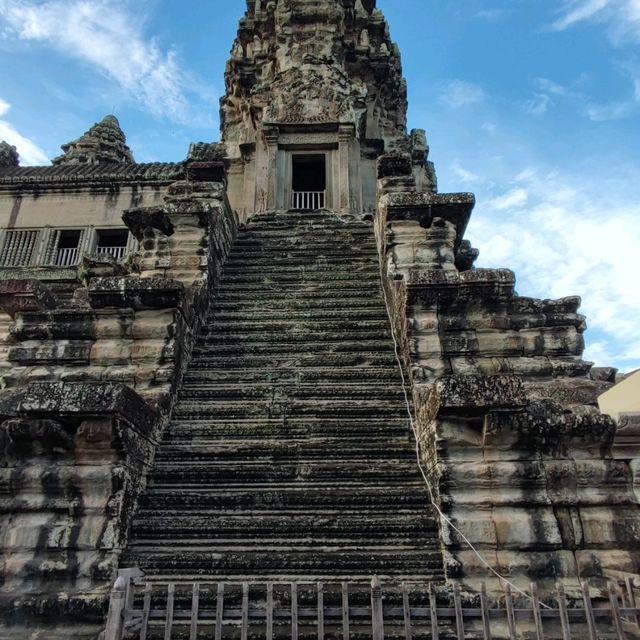Climbing the tower of Angkor Wat