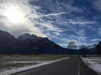 Wilderness church and snowy road scenery in the Bavarian Alps.