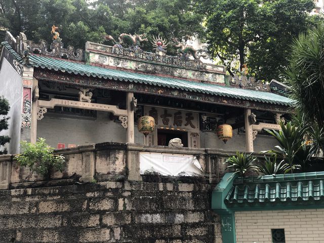 Historic temple with art work on the roof 