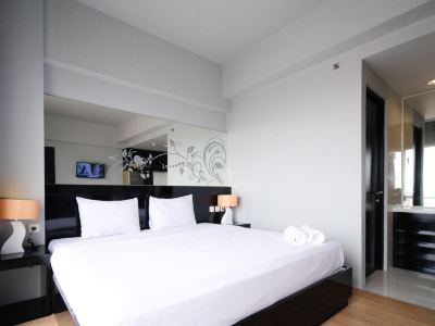 Homey Studio No Kitchen at Grand Darmo Suite Apartment by Travelio
