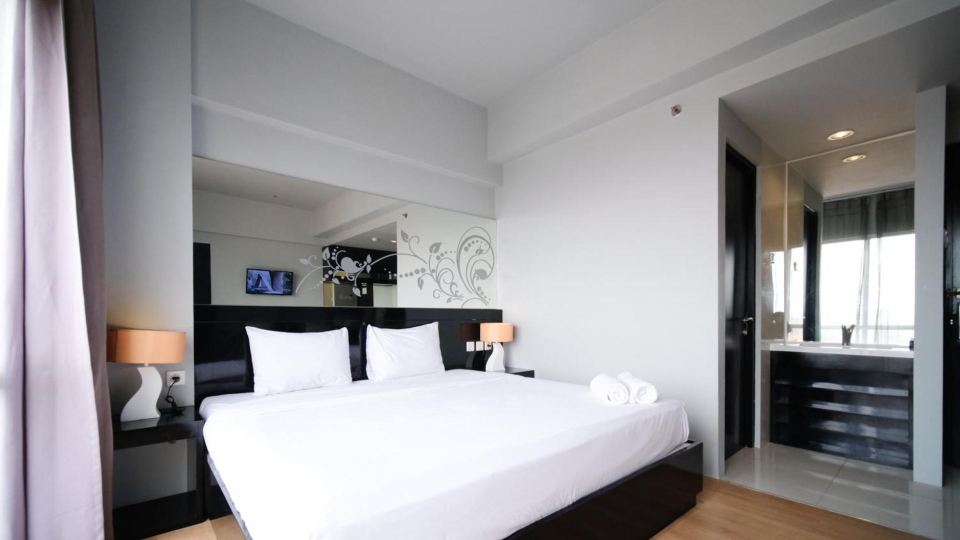 Homey Studio No Kitchen at Grand Darmo Suite Apartment by Travelio