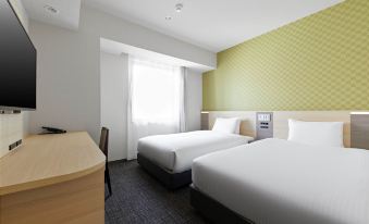 There is a bedroom with two beds and a large window on the far side at Sotetsu Fresa Inn Osaka Namba