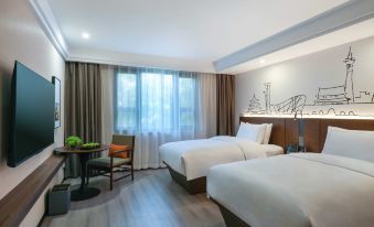 beds and a spacious table in the center at UrCove by HYATT Beijing Forbidden City