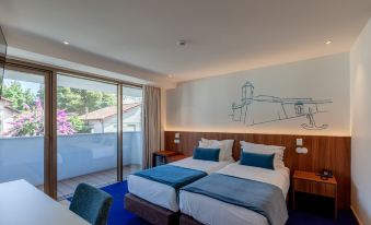 a hotel room with two beds , a desk , and a window , decorated with a mural on the wall at Sea Porto Hotel