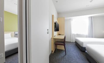 The bedroom features double beds and large sliding doors that open to the other side at Sotetsu Fresa Inn Osaka Namba