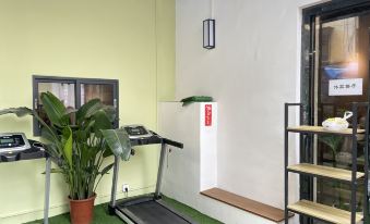 A room equipped with treadmills and an exercise bike in the center at Yue City Youth Apartment