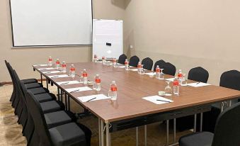 a conference room with a long table , chairs , and water bottles set up for a meeting at Swiss-Belhotel Kuantan
