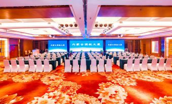 a large conference room with chairs arranged in rows and a podium at the front at Phoenix Hotel