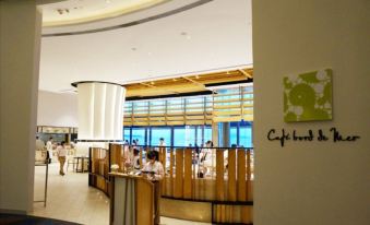 The restaurant has a counter where people are seated, and there is an open concept design in the front at Auberge Discovery Bay Hong Kong