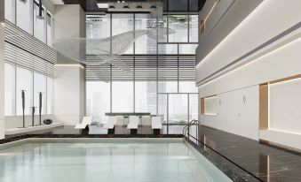 The interior of this space includes a large window and floor-to-ceiling windows that provide a view of an indoor pool at Yutai Hotel Apartment (Dongmen Pedestrian Street Luohu Port Branch)