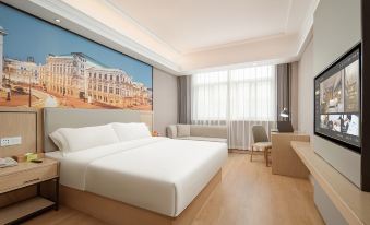 a modern bedroom with a large bed and white bedding, next to a double window at Vienna International Hotel (Shanghai Pudong Airport)