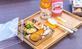 A tray containing food and drinks, including a single egg in the center at Hotel the Grang Jungmun