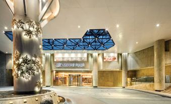 The entrance to a spacious building features an illuminated ceiling and glass partitions at Crowne Plaza Guangzhou City Centre