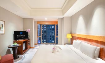 The bedroom features a double bed and a large window with a city view at Park Plaza Beijing Wangfujing