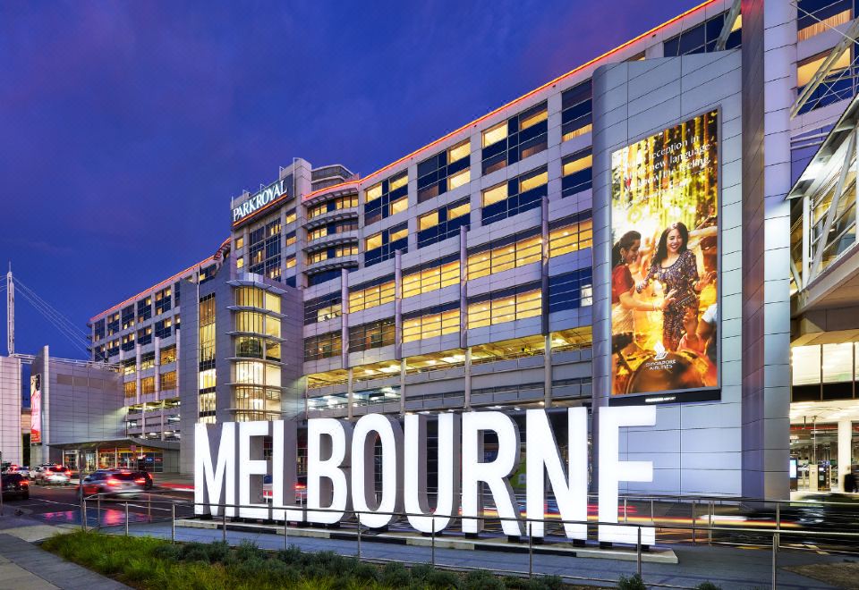 "a large hotel building with a large sign that reads "" melbourne "" prominently displayed on it" at PARKROYAL Melbourne Airport