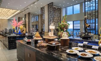 The restaurant is filled with guests dining at their own tables, which are positioned near large windows at Continental Bridge Convention Centre Lianyungang China