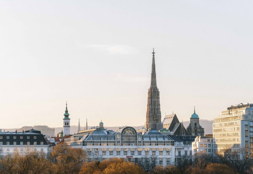 a panoramic view of the city , with tall buildings and a large church tower visible in the background at Vienna Marriott Hotel