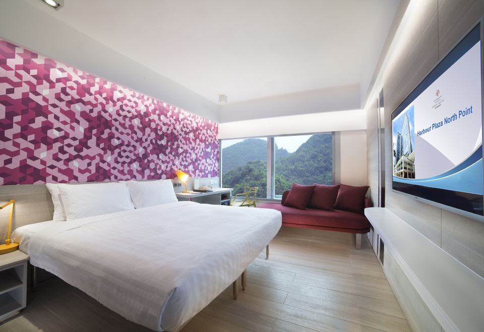 The bedroom features large windows and an attached bathroom that has been decorated at Harbour Plaza North Point