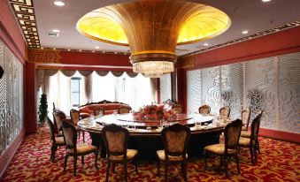 a large , ornate room with a red carpet and a chandelier hanging from the ceiling at Airport Hotel