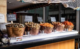 The counter features a display case with various types of meat at Holiday Inn Golden Mile