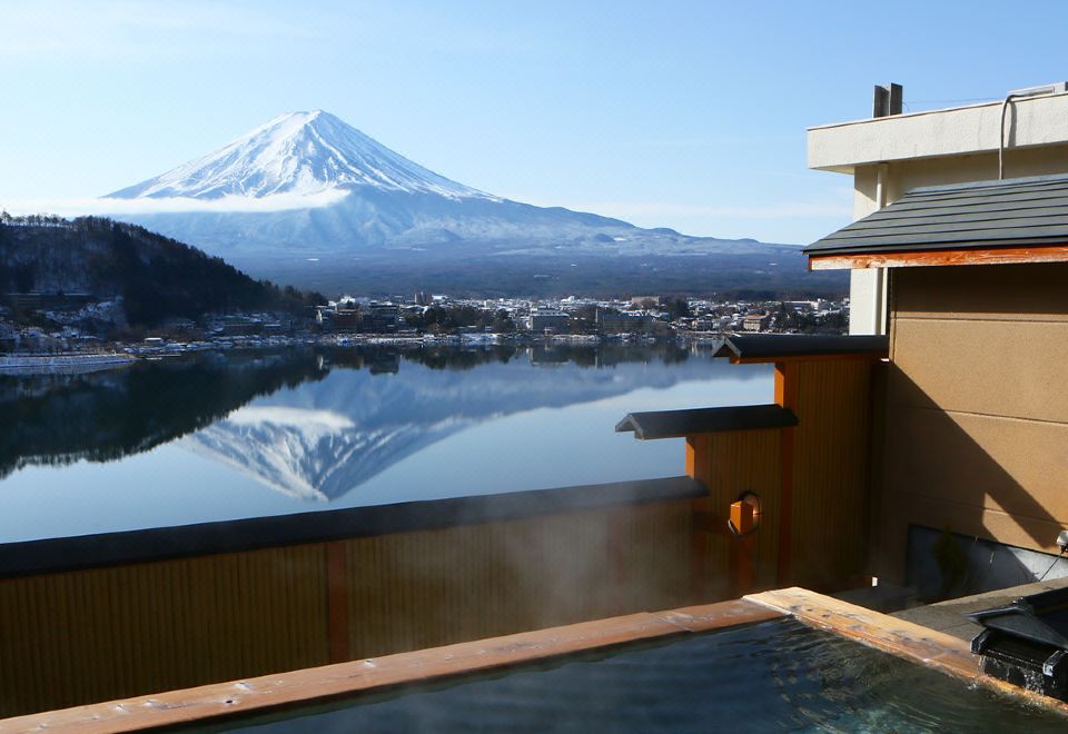 The balcony offers a scenic view of mountains and water, including an artificial mountain range at Fuji Ginkei