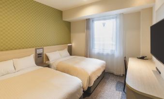 There is a bedroom with two beds and a large window on the far side at Sotetsu Fresa Inn Osaka Namba