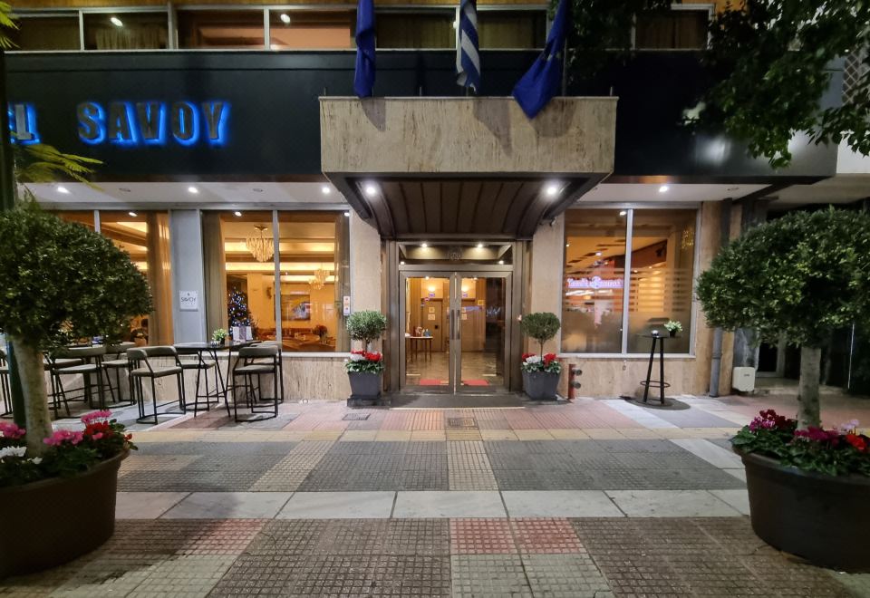 "the entrance to a building with a sign that reads "" minivi "" and several chairs outside" at Savoy Hotel