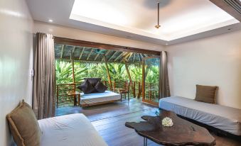 a room with two beds , one on the left and one on the right side of the room at Siargao Island Villas