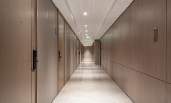 There is a long hallway with doors on each side and tiled floors at the end at Yutai Hotel Apartment (Dongmen Pedestrian Street Luohu Port Branch)