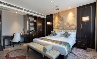 The middle room features a large bed with an oriental-style headboard and wall hangings at Zhedong Chuyue International Hotel