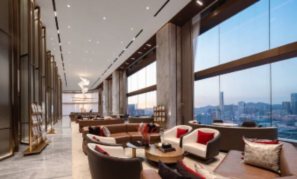 A modern living room with large windows and contemporary furniture is located in the middle, alongside another area at Yutai Hotel Apartment (Dongmen Pedestrian Street Luohu Port Branch)