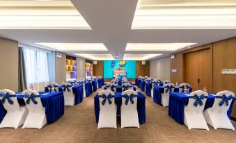 A ballroom is arranged for an event, with tables and chairs placed in the center at Park Inn by Radisson Guangzhou Railway Station Yuexiu International Congress Center