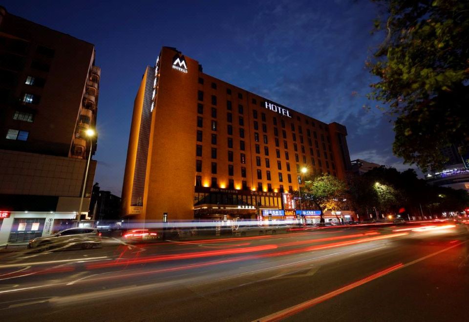 "a large hotel with a red brick exterior and the word "" hotel "" displayed on it" at M Hotels