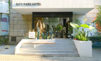 There is a restaurant with tables and chairs in front, located next to an outdoor area at CITY PARK HOTEL